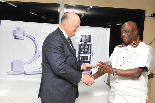  Mr Isaac O. Hood (left) presenting documents covering the equipment to Dr Felix Anyah