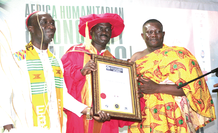 Bishop Dr James Obeng Nyantakyi (left), President of the Ecclesiastical Bishops and Leaders Conference of Africa (E.B.L.C.A), honouring Mr Yaw Sarpong (middle), a musician, with a doctorate degree, Looking on is Rev. Nana Adu Gyamfi II. Picture: INNOCENT K. OWUSU.