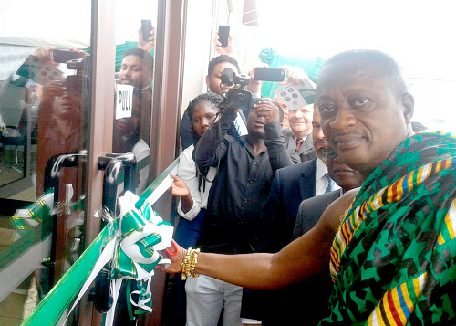 The Bantamahene cutting the tape to inaugurate the new office complex for Ecom Ghana Ltd in the Ark building in Kumasi