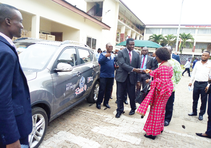 Mrs Millicent Brookman-Amissah, the General Manager of the EPP Books Services, presenting the keys to the saloon car to Dr Adutwum