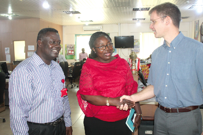 Mr Hans-Helge Sander (rght) interacting with Ms Kate Hudson  and Mr Owusu Achiaw 