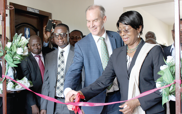 Justice Sophia A.B Akuffo (right) together with Mr Andrew Barnes (left) cutting the tape to officially launch the solar power system at the Winneba Court. Picture: INNOCENT K. OWUSU.