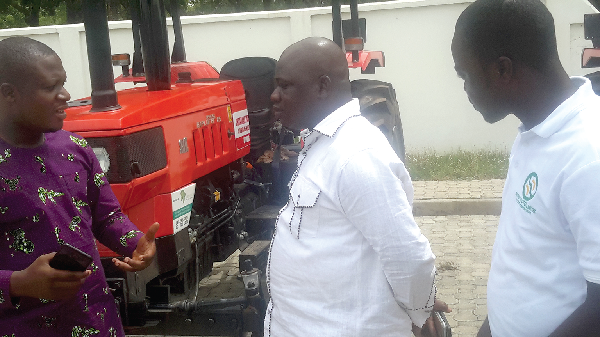 Mr Amoateng, the Chief Executive of Agro African, explaining a point to Mr Issahaku (right), the UWR Minister, at the ceremony.