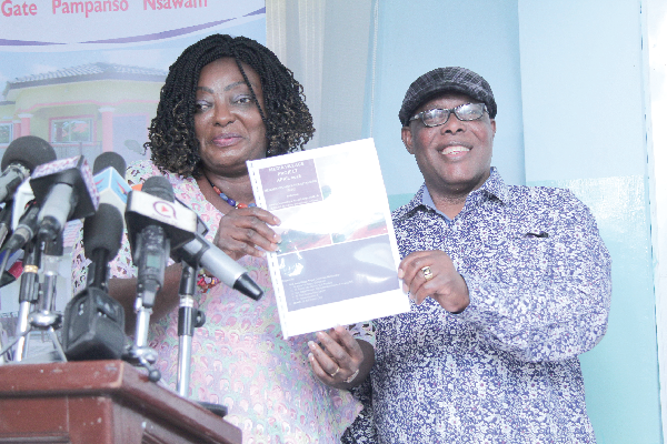 Ms Freda Prempeh (left), the Deputy Minister of Works and Housing, assisted by Nana Kwasi Gyan-Apenteng, Chairman, NMC launching the GJA media village project.