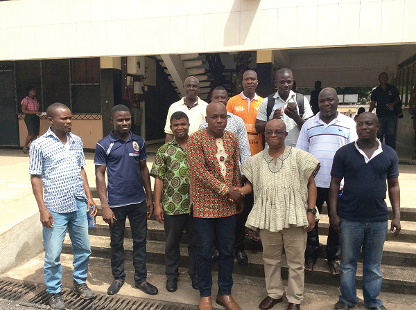 Dr Letsa (2nd right) shaking hands with Mr Vincent Hodoli. Those with them are members of the Concerned Citizens 
