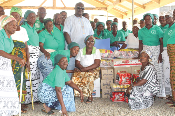 Nana Kwame Asamoah Yeboah-Afari with some beneficiaries