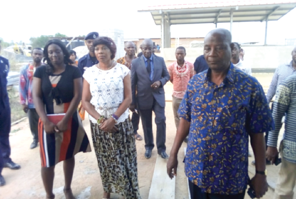 The Ada West District Director of the Ghana Health Service, Dr  Seli Deh (right), conducting Mrs Elizabeth Sackey and her entourage round the polyclinic at Sege