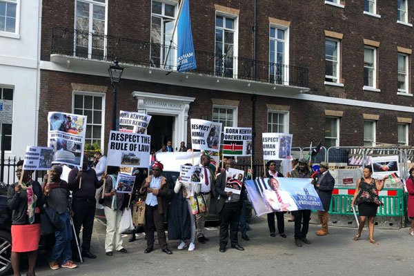 A group of Kenyans protest against President Kenyatta's rule outside Chatham House in London on April 17, 2018. 