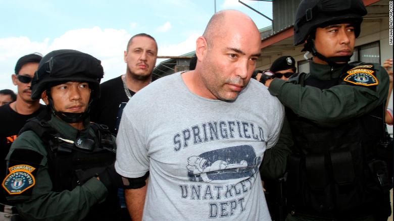 Joseph Manuel Hunter, center, is escorted by Thai police commandos after being arrested in Bangkok during a previous incident in Thailand, in September 2013.