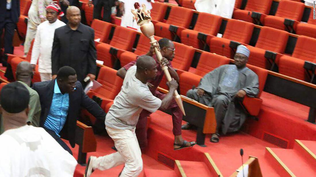 The intruders carrying Nigeria parliament's mace away