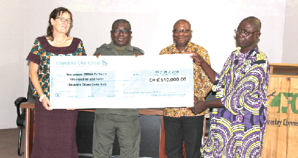Mrs Donna Sheppard (left) presenting the dummy cheque to Torgbui Allegah (right). Looking on are Nana Kofi Adu-Nsiah (2nd left) and Mr Ken Kinney (2nd right). Picture: INNOCENT K. OWUSU. 