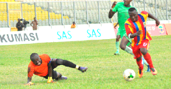 Bechem goalkeeper Ernest Adu falls on the turf as Hearts’ Patrick Razak strides to score. Picture:  EMMANUEL BAAH