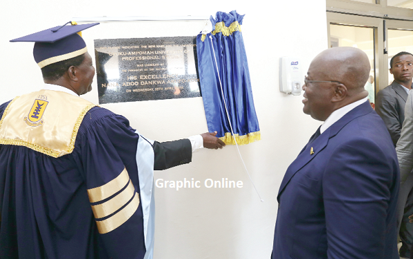 President Akufo-Addo (right) reading the inscription on the plaque after unveiling it. Picture: SAMUEL TEI ADANO