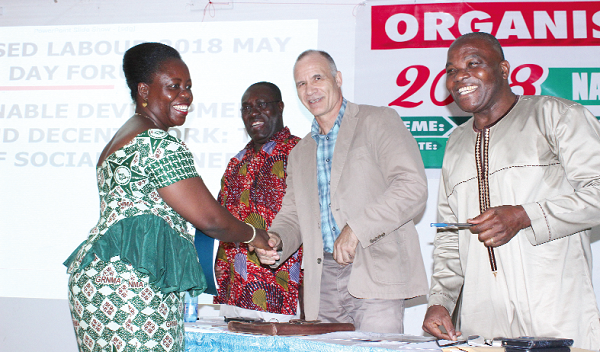 Mr Fritz Kopsieker (2nd right) interacting with Ms Perpetual Ofori-Ampofo (left), Member, National May Day Planning Committee. Looking on is Mr John Amegashie (right), Chairman, National May Day Planning Committee, and Dr Yaw Baah.  Picture: INNOCENT K. OWUSU