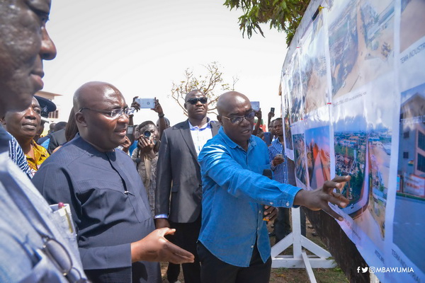 Vice-President Mahamudu  Bawumia (3rd right)  being briefed on the project designs by officials of the Department of Urban Roads. With them are the Minister of Roads and Transport, Mr Kwasi Amoako-Atta (4thright) and Mr Titus-Glover (2nd right), the MP for Tema East.