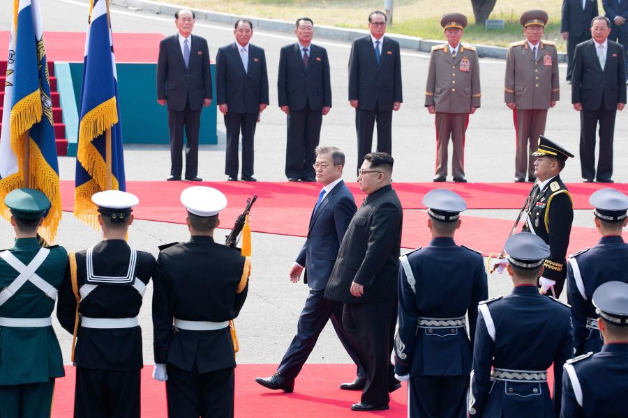 Kim Jong Un walks with Moon Jae-in down a red carpet past a welcoming ceremony to the summit. Photo credit: KOREA SUMMIT PRESS POOL/AFP/Getty Images
