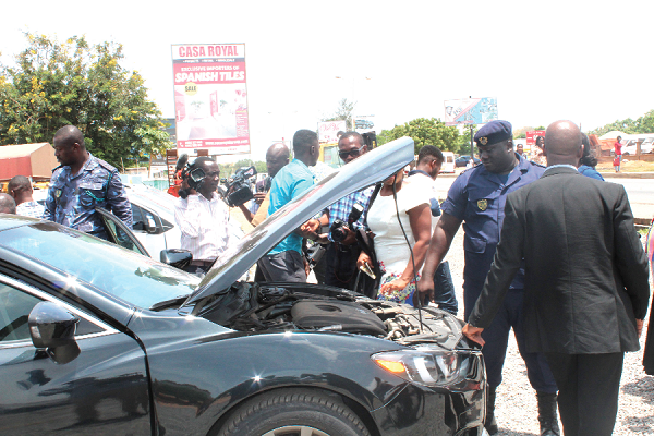  Customs officers inspecting a car suspected to have been smuggled into Ghana 