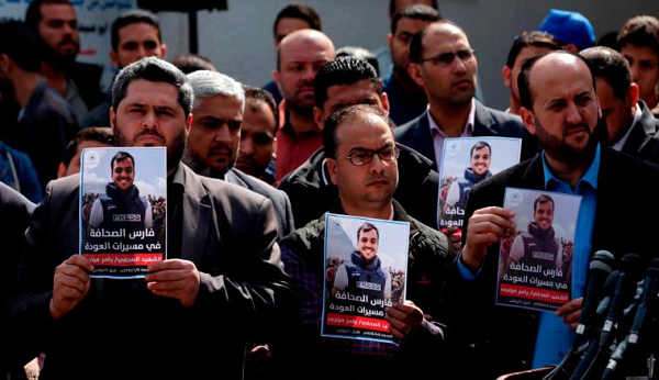 Palestinian journalists carry a portrait of a journalist during his funeral on Saturday.