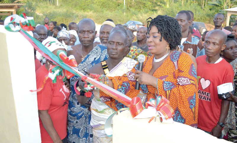 Mrs Queenstar Maame Pokuah Sawyerr cutting the tape to inaugurate the 12-seater water closet project