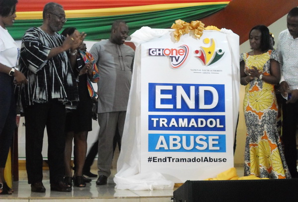 The Minister of Youth and Sports, Mr Isaac Kwame Asiamah (second left), being assisted by the Chief Executive Officer of the Food and Drugs Authority, Mrs Delese Mimi Darko (right), to lunch the campaign with an applause by Dr Nsiah-Asare (in smock)