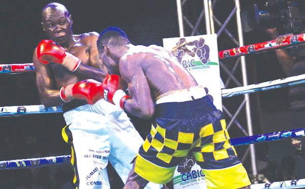 Patrick Allotey pin Badru Lusambya to the ropes during their bout. Picture Emmanuel Asamoah AddaE