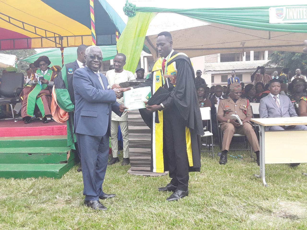 Mr Yaw Osafo-Maafo (left) presenting a special award to the Best graduate, Mr Isaac Gandaabie Domangbang