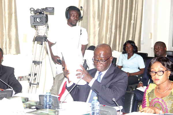 Mr Eugene Asante Ofosuhene (left), the Controller and Accountant General, showing documents to the Public Accounts Committee. Looking on is Mrs Abena Osei-Asare (2nd left), a Deputy Minister of Finance. Picture: Maxwell Ocloo