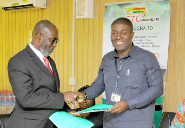 Nana Akomea (2 right) exchanging documents with Mr Benjamin Hyde after signing the agreement. With them is  Mr Samuel Oppong, Chairman of the Board of Directors of STC. 
