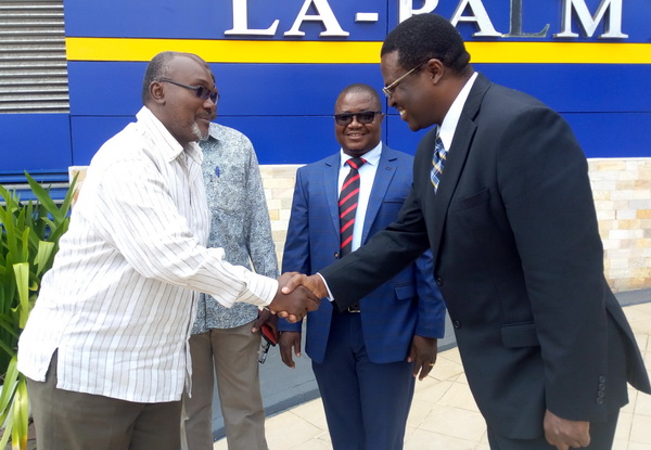 Dr Martin Fregene, Director, Agriculture and Agro-industry Department (AHAI) of AfDB (right) in a handshake with Mr Robert Patrick Ankobiah (left), the acting Chief Director of MOFA, at the workshop