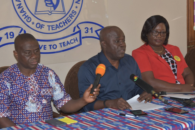 Mr David Ofori Acheampong, General Secretary of GNAT, addressing the media. With him are Mr Richard Komla Sagodo (left), Head of Organisation and Administration, and Ms Phillippa Larsen, National President, both of GNAT