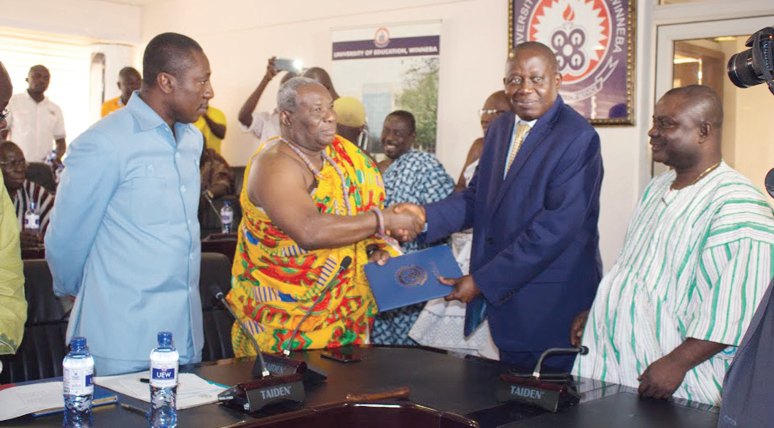 The acting Vice-Chancellor of the UEW, Prof. Anthony Afful-Broni (2nd right), presenting a copy of the MoU to Nenyi Ghartey VII. Looking on are Mr Alex Afenyo-Markin, the NPP MP for Effutu, and Mr Paul Osei Barimah (1st right), the Registrar of UEW