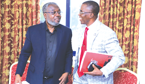 Prof. Jacob Plange-Rhule (right), interacting with Dr Anothony Nsiah-Asare after the symposium