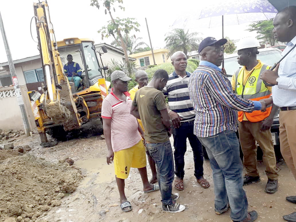  Mr Felix Mensah Anag-La (2rd right) interating with construction workers. INSET: Portion of the construction