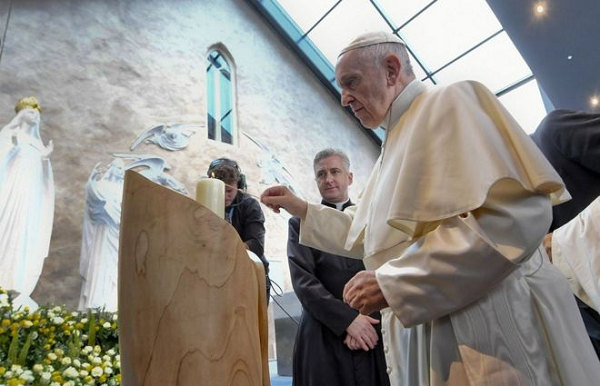 There was silence at the basilica at Knock as Pope Francis lit a candle and prayed