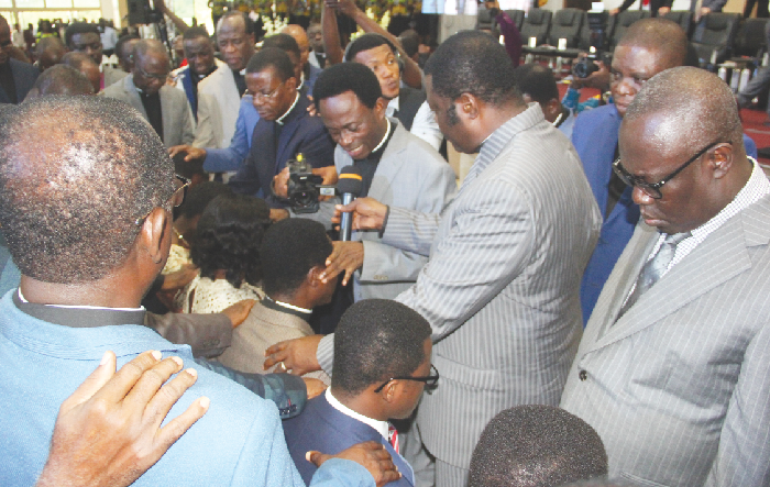 Some of the ministers praying for Apostle Eric Kwabena Nyamekye, the new Chairman of COP and his family. Picture: MAXWELL OCLOO