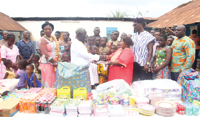 Mr Yaw Osafo-Maafo (arrowed), Senior Minister, presenting the items to Ms Philomina Asantewaa Agyei (3rd left), Founder, Good Shepherd Development Outreach, Akwatia, while Mrs Mercy Ama Sey (left), the MP for Akwatia and others look on. Picture: Maxwell Ocloo