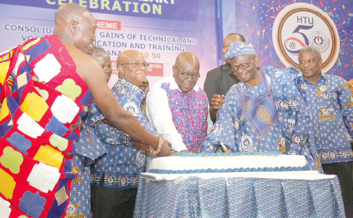 President Nana Addo Dankwa Akufo-Addo cutting the anniversary cake together with Dr Archibald Letsa (2nd left), the Volta Regional Minister, and some members of the university council of the Ho Technical University. Behind them is Dr Mathew Opoku Prempeh, Minister of Education Picture: SAMUEL TEI ADANO