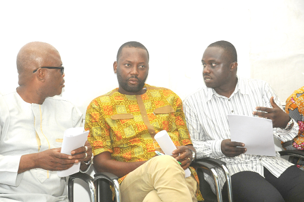 Mr Emmanuel Yirenkyi Antwi (right) Operations Director of the Ghana National Association of Small Scale Mining conferring with his executive members during the press conference. Picture: EBOW HANSON