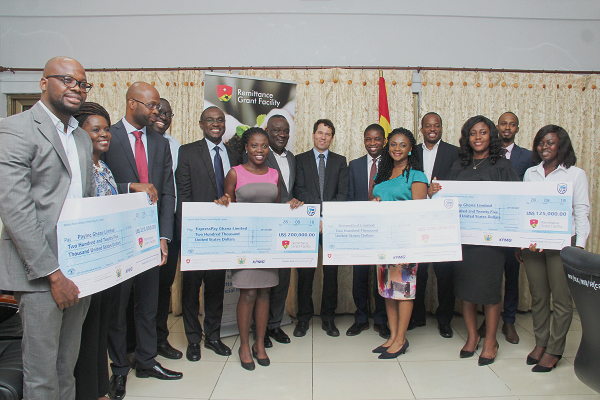 Mr Daniel Lauchenauer (7th left), the Deputy Head of Co-operation, Embassy of Switzerland in Ghana; Mr Sampson Akligoh (8th left), Director, Financial Sector Division, Ministry of Finance, and the beneficiaries of the Switzerland grant