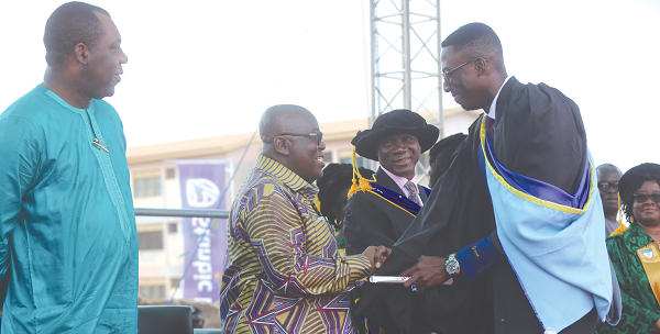 President Nana Addo Dankwa Akufo-Addo (2nd left) congratulating Mr Awini Asitanga Awinpang Dominic (right), the Overall Best Student at the 12th graduation ceremony of the Ghana Institute of Journalism (GIJ). Looking on is Dr Matthew Opoku Prempeh (left), the Minister of Education Picture : SAMUEL TEI ADANO