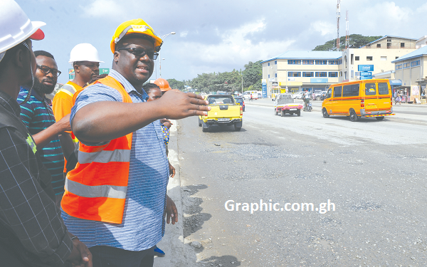 Mr George Asiedu, the coordinator of the project, explaining to some journalists why the road will be closed to motorists. Picture: EMMANUEL QUAYE