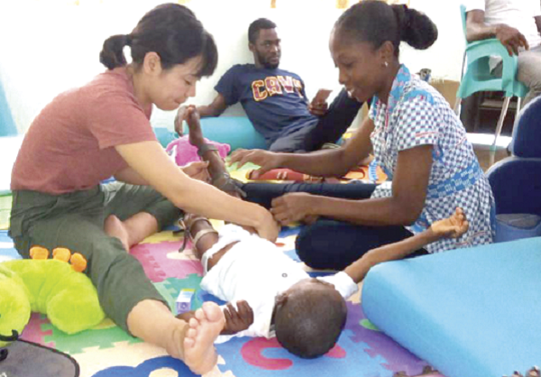 Caregivers attending to a child with special needs.