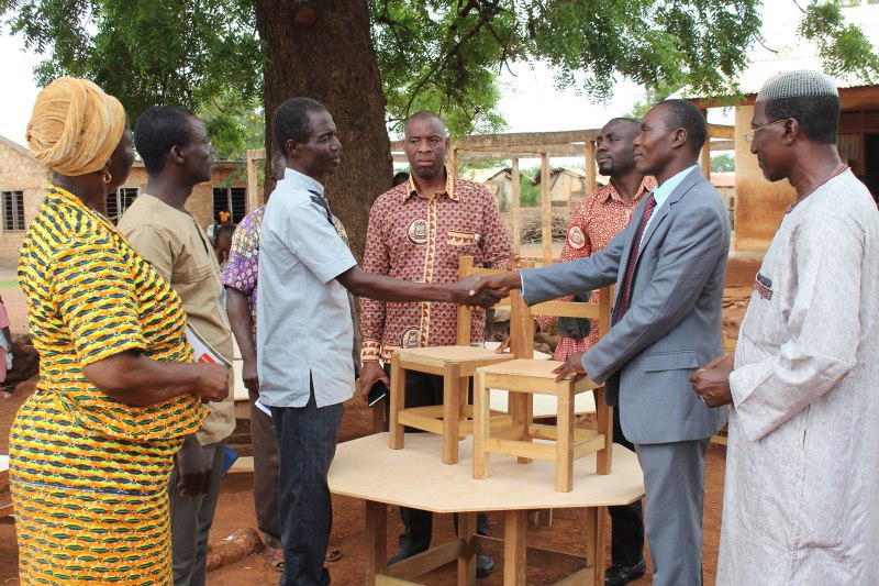 Mr Muntari Mahama (right) presents the items to Mr Ambrose Tengang