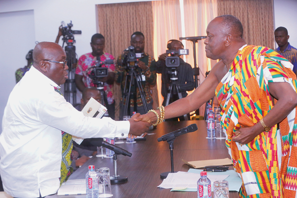 President Nana Addo Dankwa Akufo-Addo thanking Nana Otuo Siriboe II (right), Chairman, Council of State after receiving the report at the Jubilee House in Accra. Picture: SAMUEL TEI ADANO