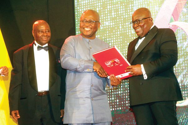 Dr Yaw Adu Gyamfi (left) presenting a commemorative book on AGI@60 to President Akufo-Addo. Picture: SAMUEL TEI ADANO