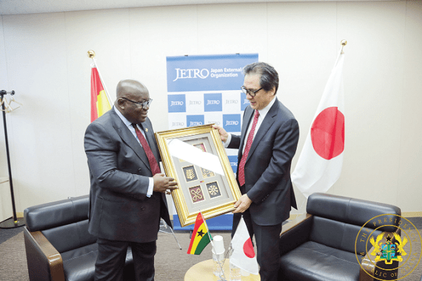 President Akufo-Addo presenting a gift to Mr Hiroyuki Ishige, the Chairman of JETRO 