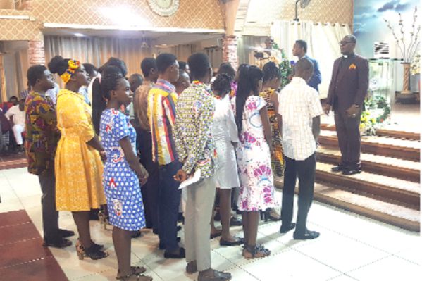 Apostle Stephen K. Amoani praying for the scholarship beneficiaries