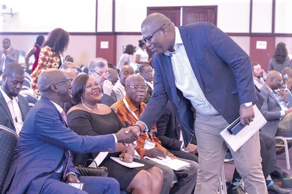 Mr Egbert Faibille Jnr (right) exchanging pleasantries with some of the participants