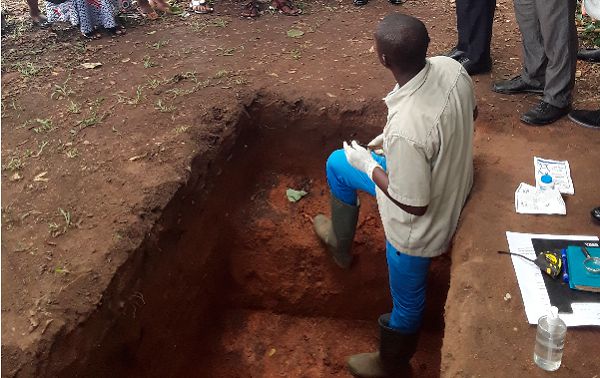 A soil scientist taking the dignitaries through soil structure during the opening day