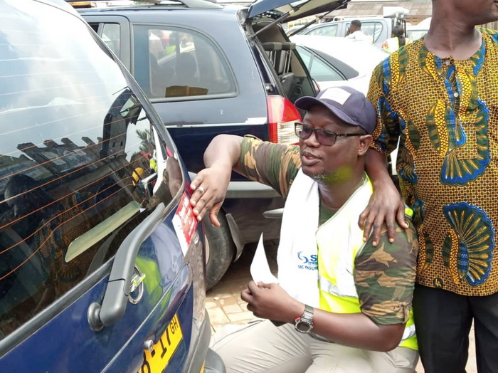 Mr M. Dotsey Koblah Aklorbortu, Western Regional Chairman of the GJA, puting stickers on vehicles as part of the campaign 